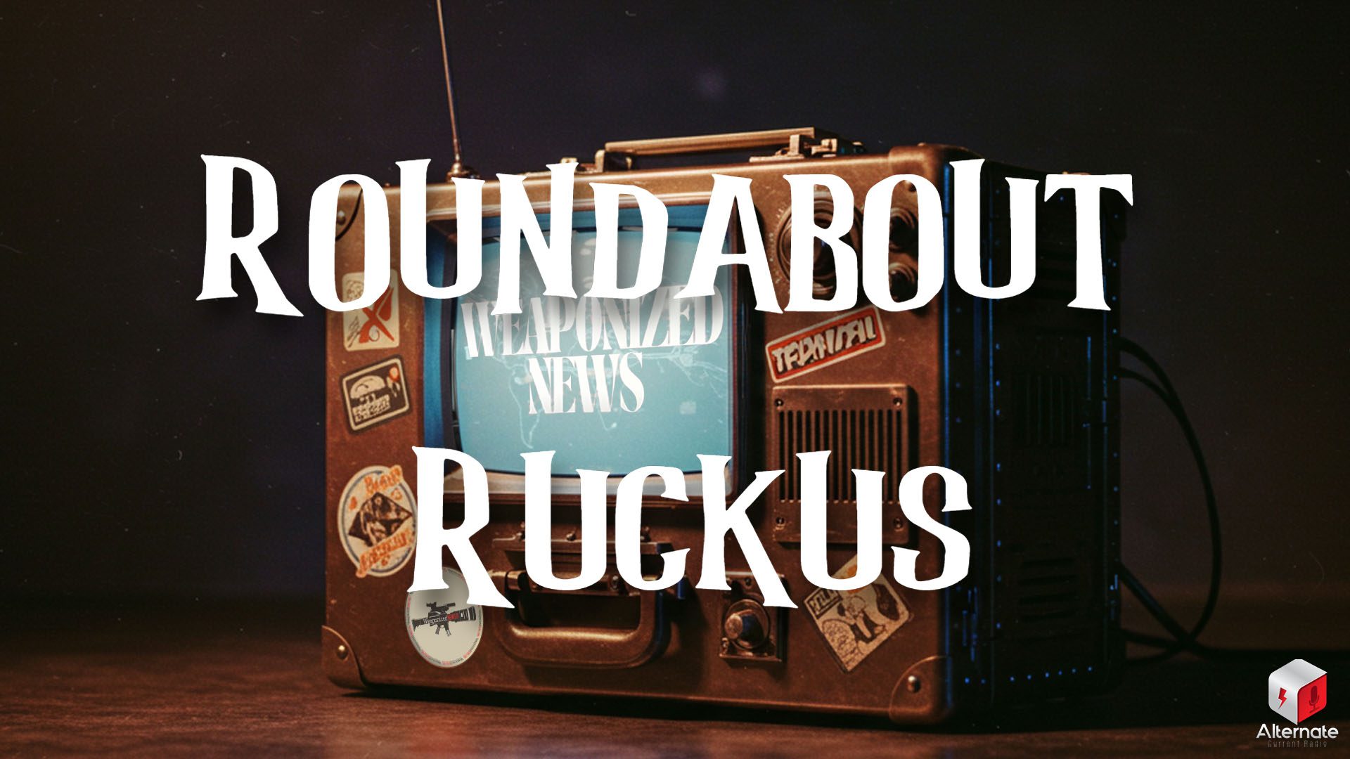 A device that looks like a combination of a peice of luggage and a vintage CRT television - with knobs and buttons on the right side, an antenna on top, and a handle on the front. The device also has several passport/travel style stickers affixed to the body.