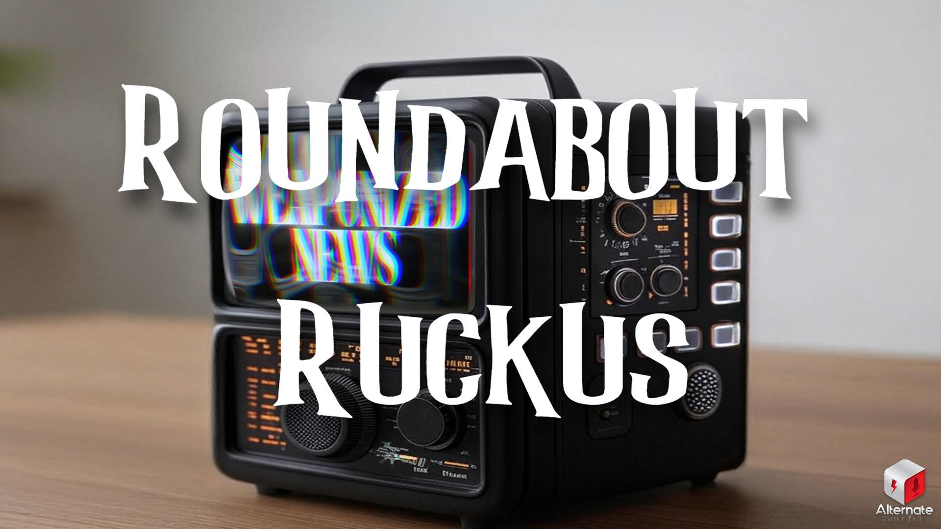 Ruckus on Weaponized News (03-OCT-25) A sleek retro-style device combining a CRT-style screen and a control panel with knobs and illuminated buttons sits on a wooden surface.
